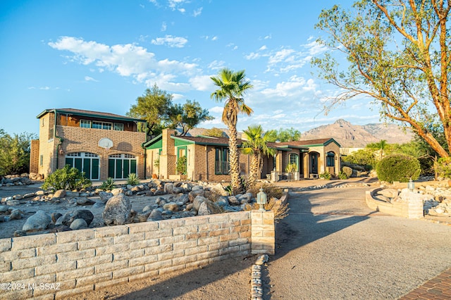 view of front facade featuring brick siding and a mountain view