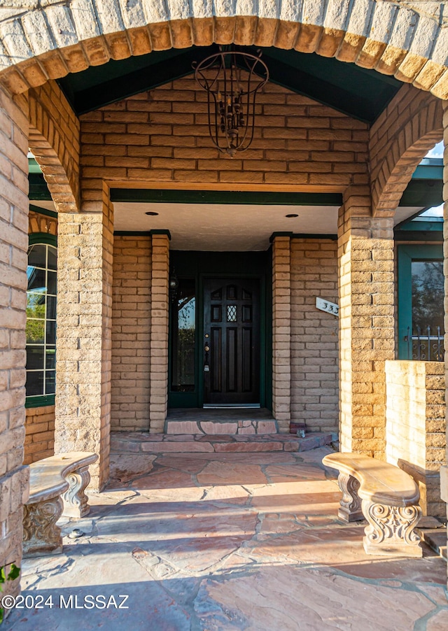 property entrance featuring brick siding