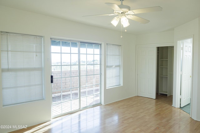 unfurnished room with ceiling fan and light wood-type flooring