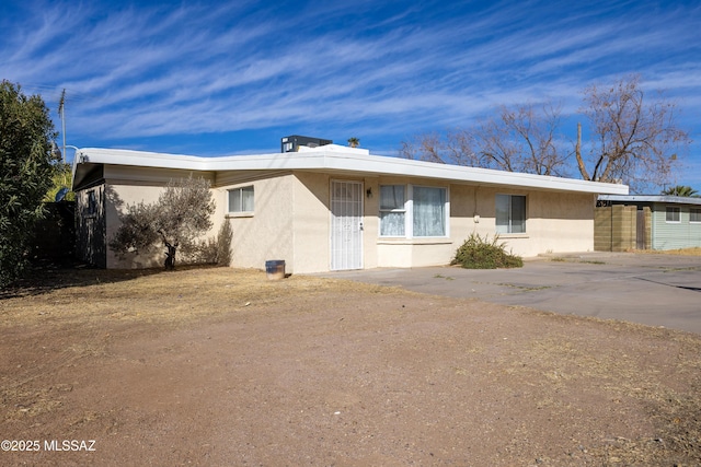 ranch-style home with stucco siding