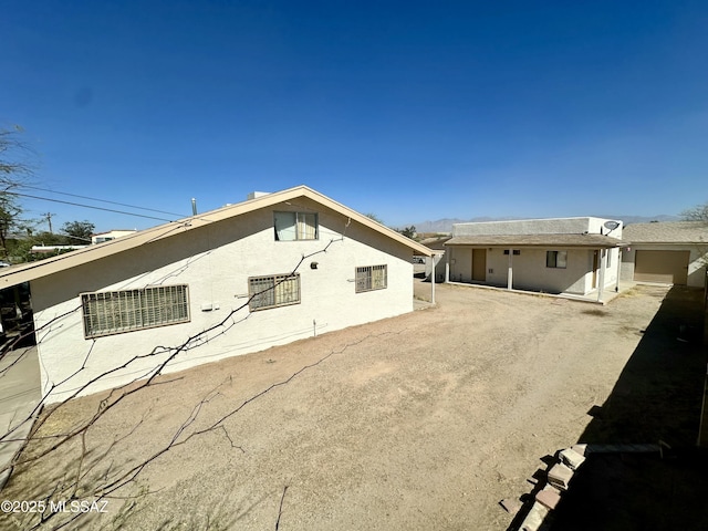 back of house featuring stucco siding