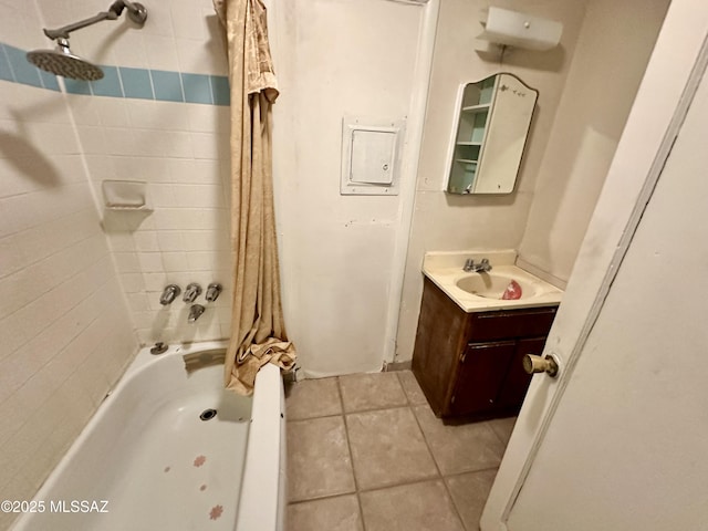 bathroom with tile patterned floors, vanity, and shower / bath combo with shower curtain