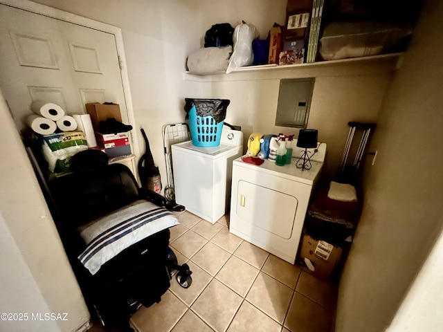 clothes washing area with laundry area, tile patterned floors, electric panel, and washing machine and clothes dryer