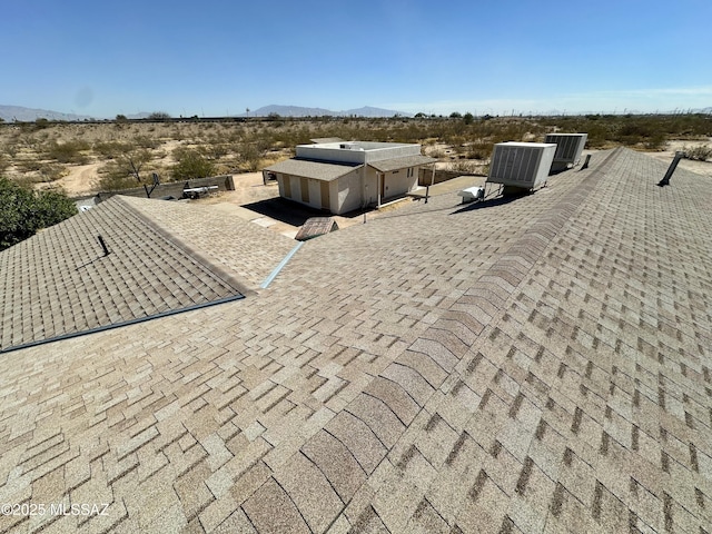 details with a shingled roof and a mountain view