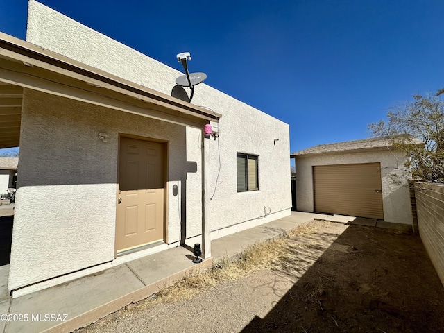 entrance to property featuring stucco siding