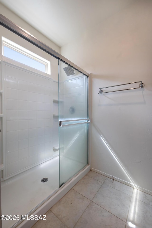 full bathroom featuring a stall shower and tile patterned flooring