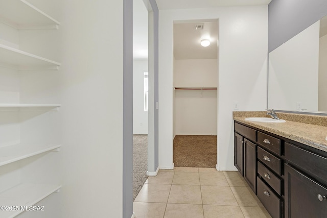 full bathroom with visible vents, a spacious closet, vanity, and tile patterned floors