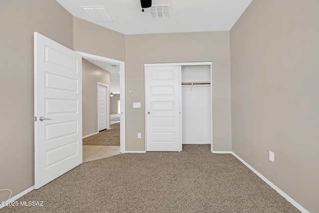 unfurnished bedroom featuring baseboards, visible vents, and carpet flooring