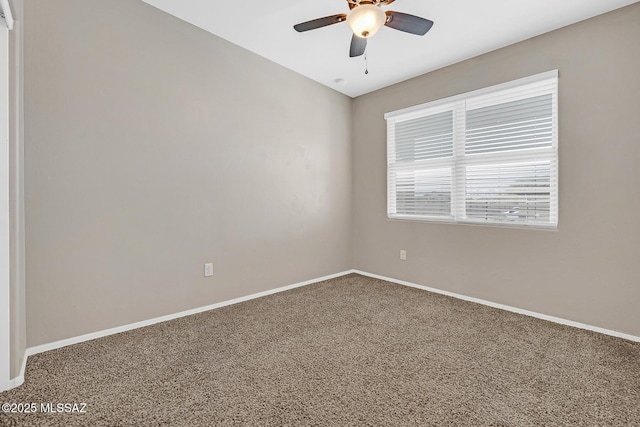 spare room with carpet flooring, a ceiling fan, and baseboards