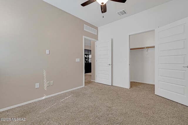 unfurnished bedroom with carpet floors, a closet, visible vents, and baseboards