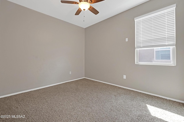 empty room with carpet flooring, ceiling fan, and baseboards