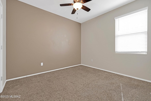 empty room with a ceiling fan, carpet flooring, and baseboards