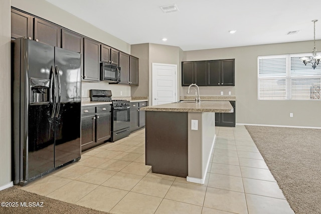 kitchen featuring visible vents, light countertops, black appliances, a sink, and light tile patterned flooring