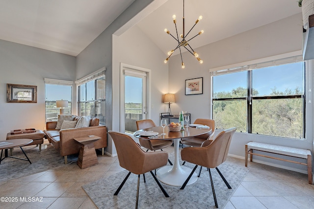 dining room featuring plenty of natural light, baseboards, light tile patterned floors, and a chandelier