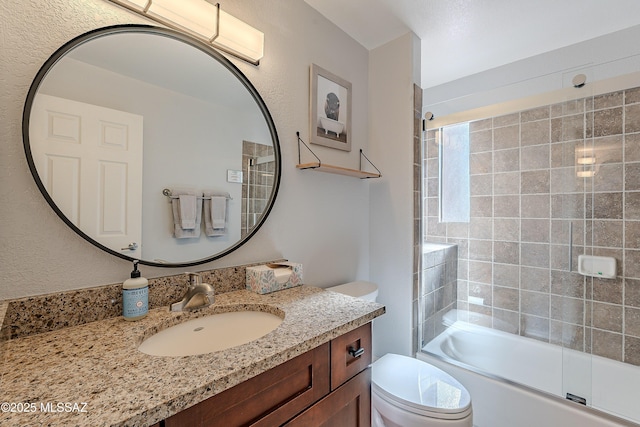 bathroom featuring toilet, vanity, and  shower combination