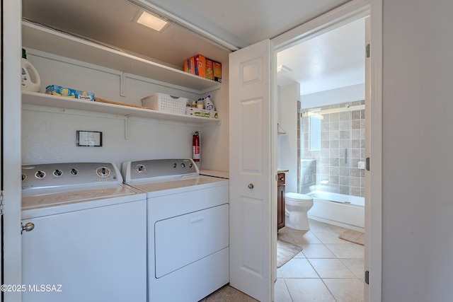 washroom featuring light tile patterned floors, laundry area, and independent washer and dryer