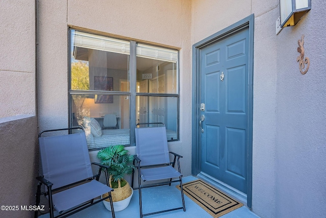 property entrance with stucco siding