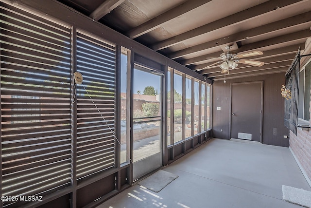 unfurnished sunroom featuring a ceiling fan and visible vents