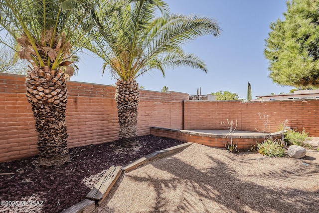 view of yard featuring a patio area and a fenced backyard