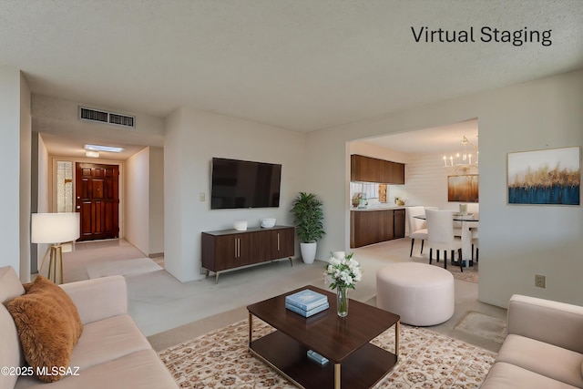 living room featuring visible vents, light colored carpet, and an inviting chandelier