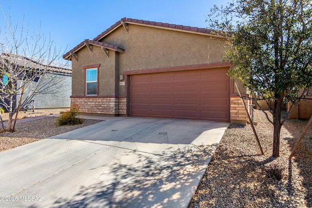 view of front facade with fence, a tile roof, stone siding, driveway, and stucco siding