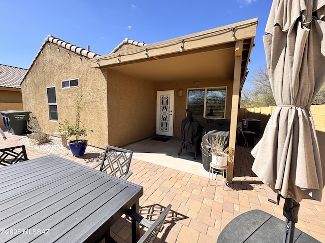 view of patio / terrace featuring fence and outdoor dining area