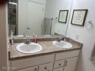 full bath with a sink and double vanity