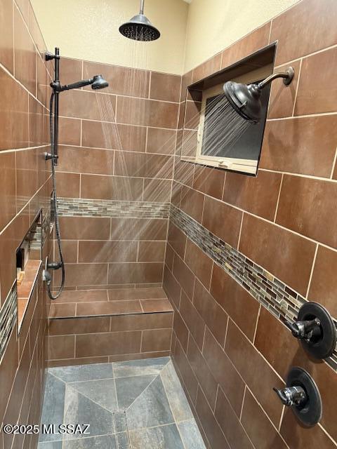 bathroom with a tile shower