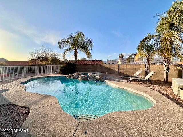 view of pool with a fenced backyard, a fenced in pool, and a patio