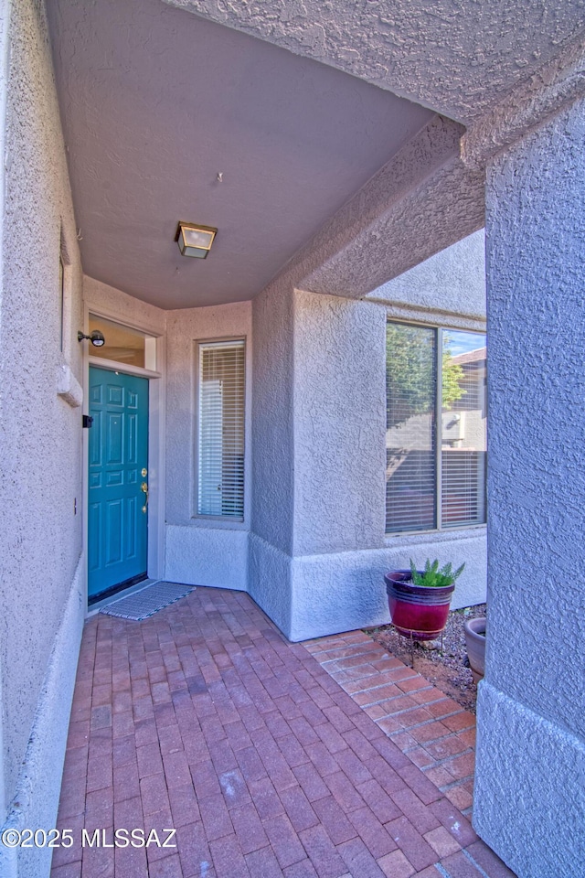 4621 S Pinnacle Peak Dr, Green Valley, AZ 85622 - view of exterior entry with stucco siding and a patio