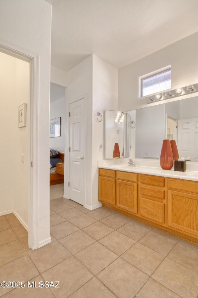 4621 S Pinnacle Peak Dr, Green Valley, AZ 85622 - full bath with tile patterned flooring, double vanity, and baseboards