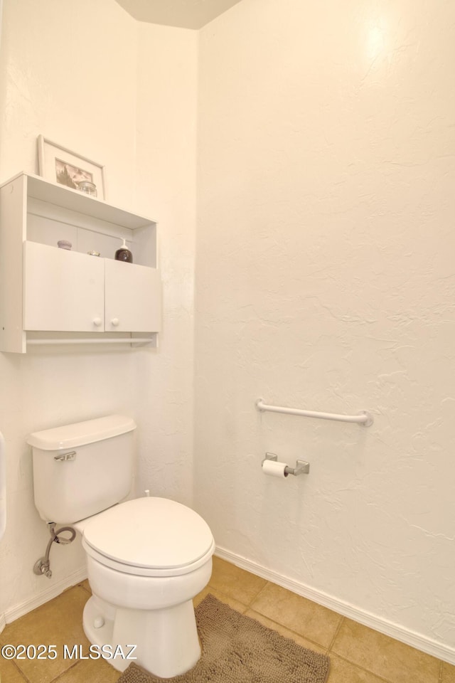 4621 S Pinnacle Peak Dr, Green Valley, AZ 85622 - bathroom with toilet, baseboards, and tile patterned flooring