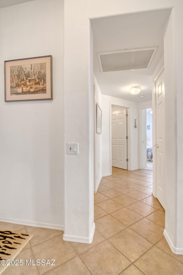 4621 S Pinnacle Peak Dr, Green Valley, AZ 85622 - hallway with light tile patterned flooring, attic access, and baseboards