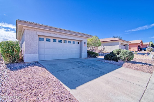 4621 S Pinnacle Peak Dr, Green Valley, AZ 85622 - view of front of home with a garage, stucco siding, and concrete driveway