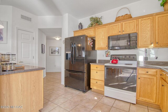 4621 S Pinnacle Peak Dr, Green Valley, AZ 85622 - kitchen with black appliances, light tile patterned flooring, and dark countertops