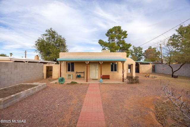 exterior space featuring a fenced backyard and stucco siding