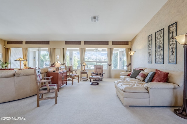 living area featuring visible vents and carpet floors