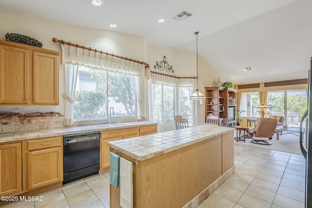 kitchen with a sink, visible vents, black dishwasher, and tile counters