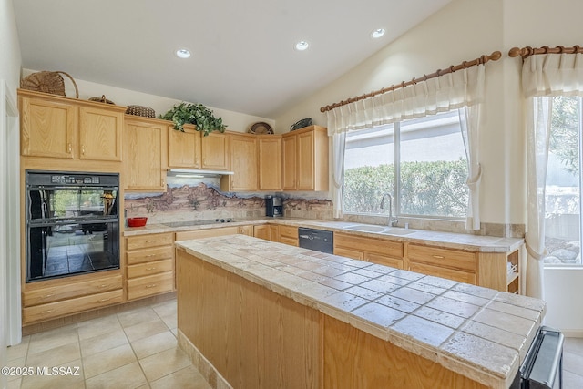 kitchen with tile countertops, light brown cabinetry, a sink, black appliances, and a wealth of natural light