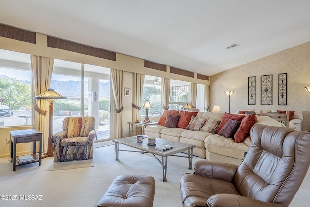 living area featuring visible vents, carpet, and vaulted ceiling