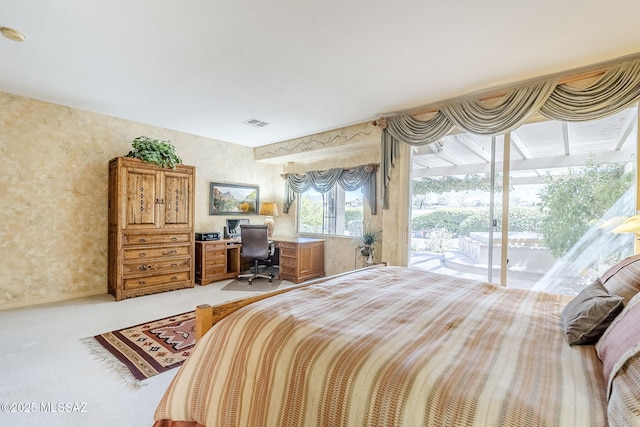 carpeted bedroom featuring visible vents and access to outside