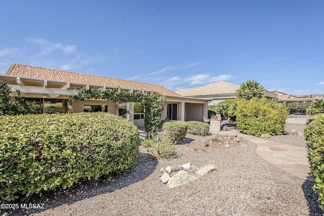 view of front of home with stucco siding and a tile roof