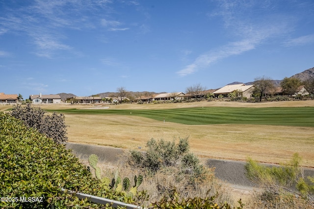 view of home's community with golf course view and a lawn