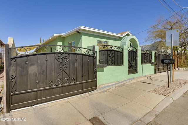 view of gate with a fenced front yard