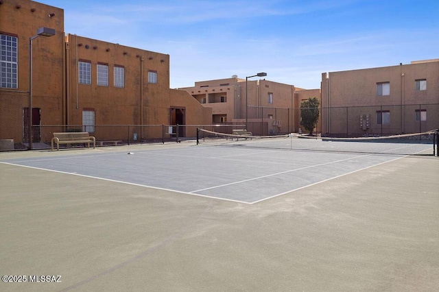 view of sport court featuring fence