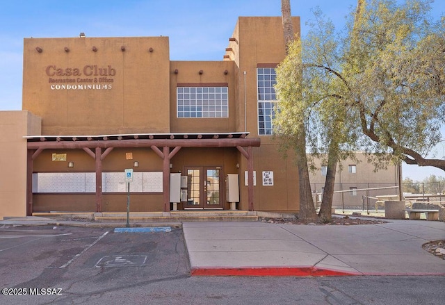 view of property featuring uncovered parking and fence