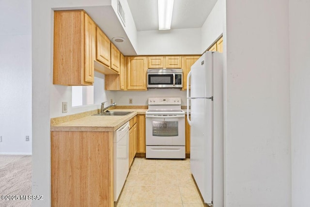 kitchen featuring white appliances, light tile patterned floors, visible vents, light countertops, and a sink