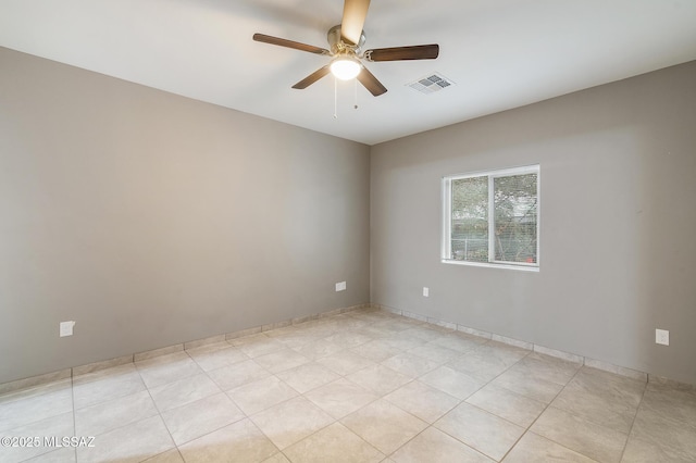 empty room featuring ceiling fan and visible vents