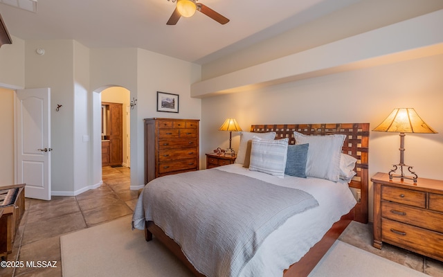 bedroom with visible vents, arched walkways, baseboards, and ceiling fan