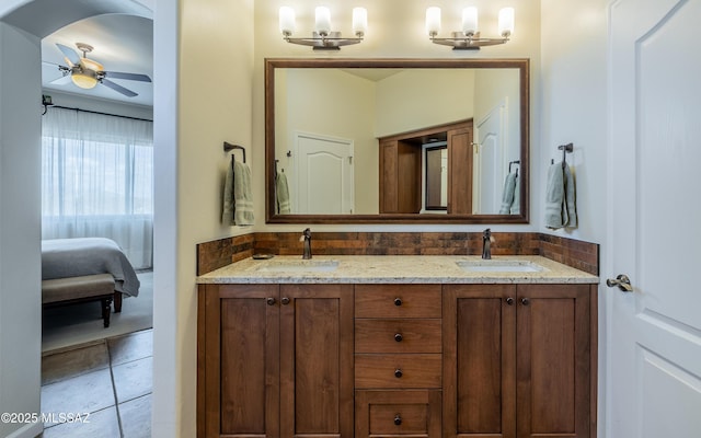 full bathroom featuring double vanity, tile patterned floors, a ceiling fan, and a sink